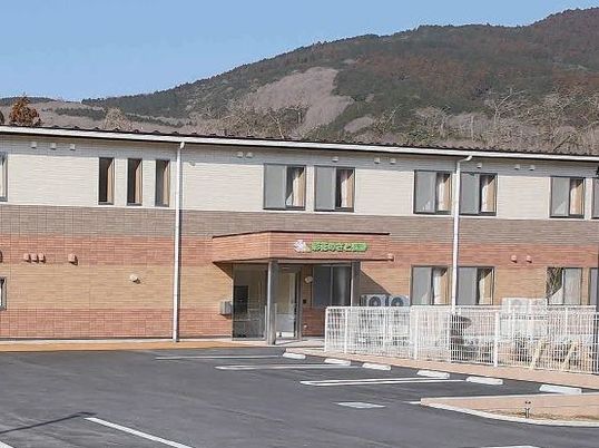 ２階建てのコーポのような色合いの建物。サービス付き住宅の外観写真