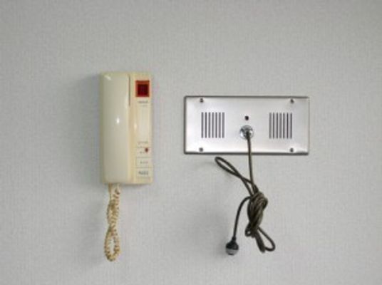 受話器がついた緊急コールの写真。壁に備え付けられている設備