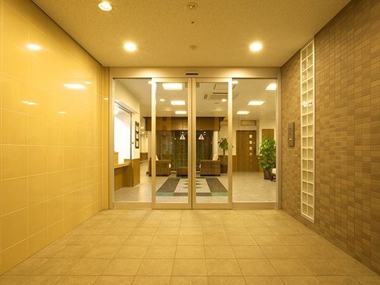 ホテルの入り口のような雰囲気の施設内。シックな色合いの施設のエントランス