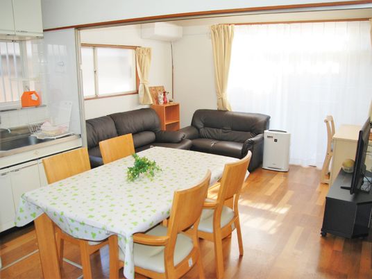 ソファが置いてあるリラックススペースと椅子とテーブルがあるダイニングルーム