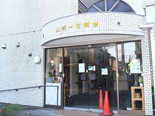 エントランスにはホーム名が書かれた屋根が付き、自動ドアや手すり付きのスロープが設置されている。