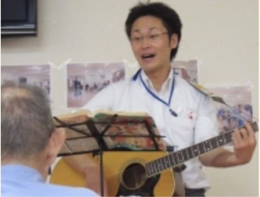 イベント。スタッフがギターの弾き語りを披露している