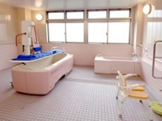 寝たきりの人に合わせた介護浴槽が写っている施設内らしき写真