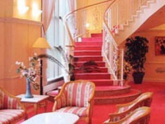 らせん状の階段が設置された館内は赤を基調としていて、赤と白と花柄のストライプ柄の椅子がセットされたテーブルが中央に置かれている。