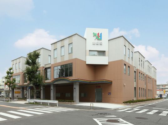 ２階建ての建物は白とブラウンで道路に面して建てられていて、真正面にホーム名が書かれている。