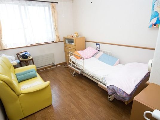 ソファやベッドが置かれている居室はフローリングで段差がなく、窓が大きく明るい。