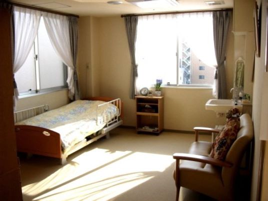 ベッドやソファがゆったりと配置された広い居室は、明るい陽射しが注ぐ空間。洗面設備も完備しています。