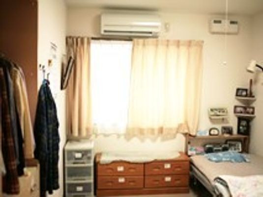 入居者が持ち込んだ家具やベッド、エアコンが置かれてた個室の部屋。