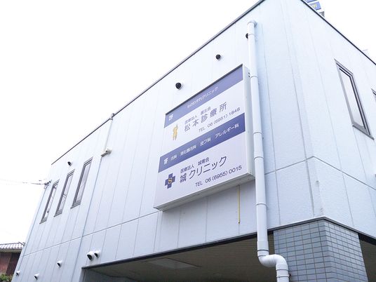 まっすぐな廊下にはシルバーの手すりが付き、居室のドアはすべて引き戸で表札がそれぞれのドアのそばに設置されている。