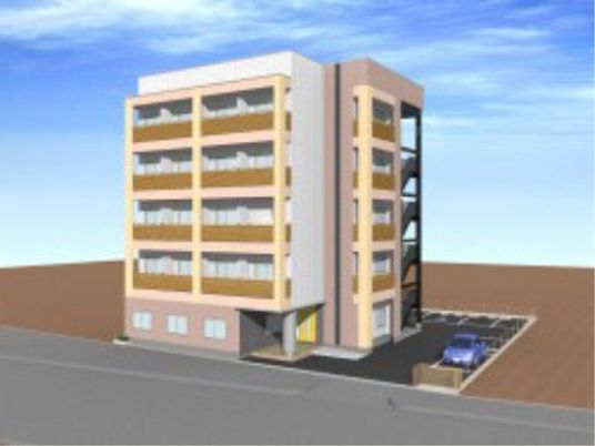 シンプルで街並に馴染むデザインの同社運営施設の外観と駐車スペース