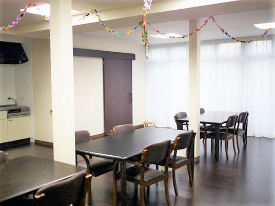 折り紙の輪飾りが飾られた食堂には、ダイニングテーブルやキッチンもある。