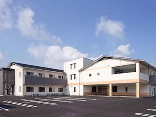 高齢者向け住宅みらいの外観とデイサービスの入り口付近。鉄骨造の建物の外観