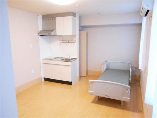 シンプルな居室にはベッドとIHクッキングヒーターを設置したキッチンが付いている。