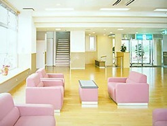 ピンク色のソファが複数組置いてあるリラックススペースの様子。オールバリアフリーの床が移っている