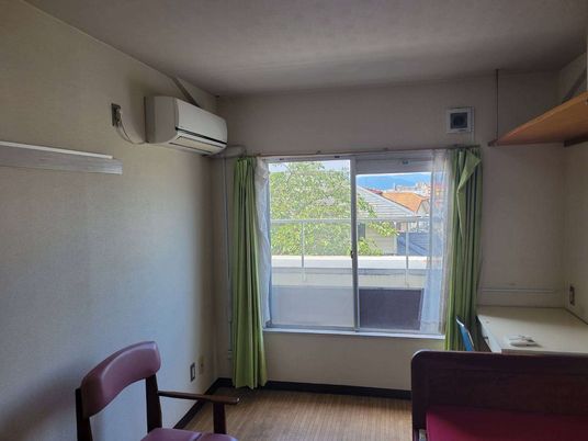 ベッドが置いてある小さなワンルームタイプの部屋。施設内の居室の様子