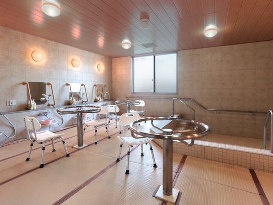 畳が敷かれた浴室にはシャワースペースやシャワーチェアが置かれ、大きな浴槽もある。