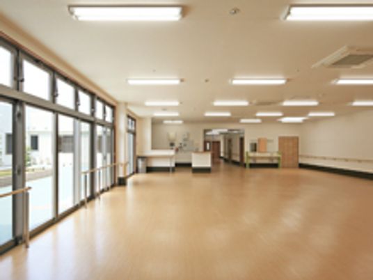 左側に一面窓が並ぶ明るいホールの様子。何も置かれていない入居前の様子