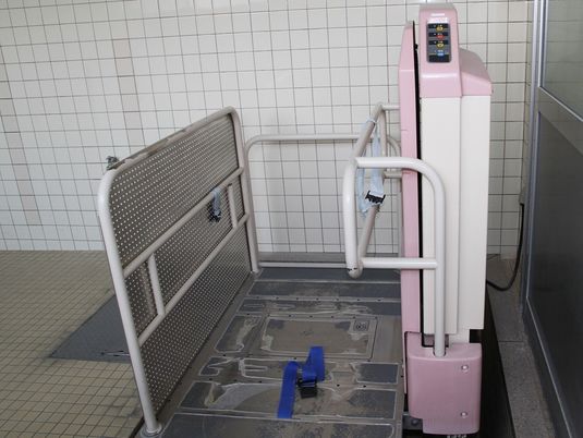 白いタイルが貼られた浴室にはリフト浴が設置され、余計なものは置かれていない。