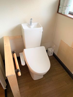 手すりがついたトイレの様子。シンプルな作りのトイレに立ち上がりの補助がついている