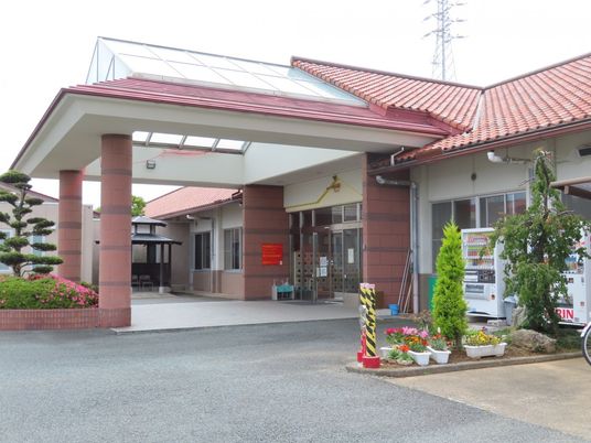 花や自販機のある玄関外観  