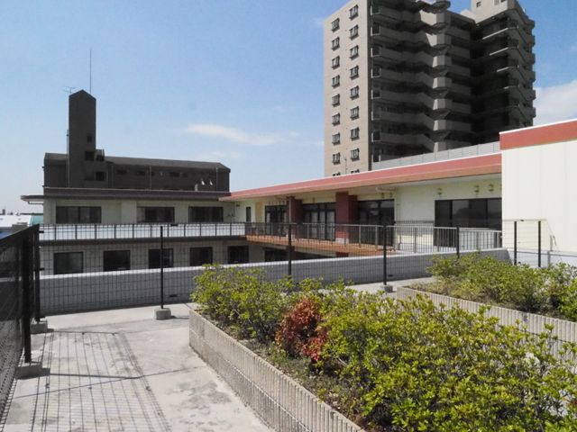 明るい屋外の共有スペース 屋上庭園 ゆとりある中庭が、日々の憩いの場を提供しています。開放的な空間で心地よいひとときをお過ごしいただけます。