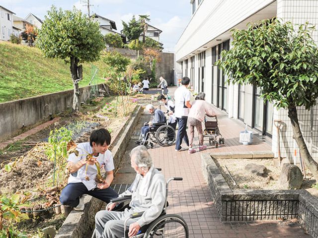 庭での活動の様子 庭 庭では居住者が日光を浴びながら、車椅子での移動も快適に楽しめます。通り抜けしやすい動線が確保されています。