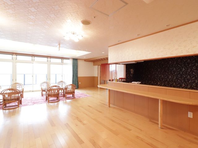 広々とした明るい食堂 共有スペース 窓から自然光が差し込む広々として暖かみのある食堂です。調理カウンターがあり、手厚いサービスを提供しています。