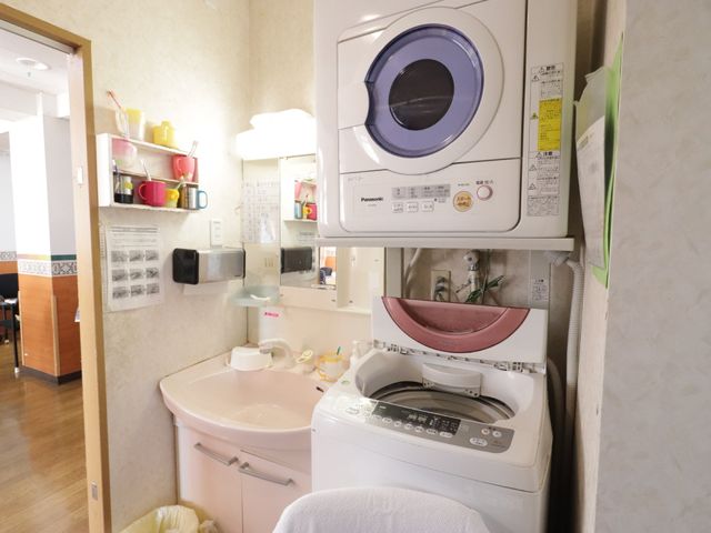 洗濯機と洗面台の設備 洗面所 清潔感ある洗面台と洗濯機が設置されており、日々の生活に必要な機能が整っています。職員としても快適にお仕事がしやすい環境です。