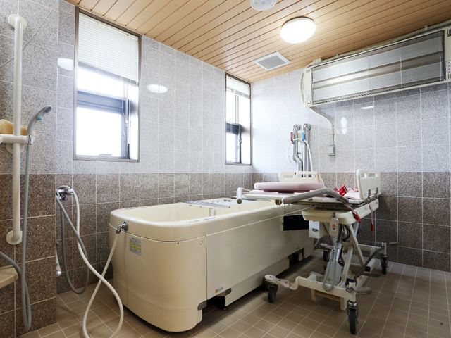 快適な浴室設備 浴室その1 清潔感のあふれる浴室は、リフト機能付きの浴槽を備え、安全に入浴をサポートします。温もりのあるデザインで、ゆったりとした時間を過ごせる空間です。