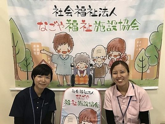 職員が並ぶ掲示物前  