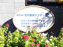 丸い看板と緑の花壇