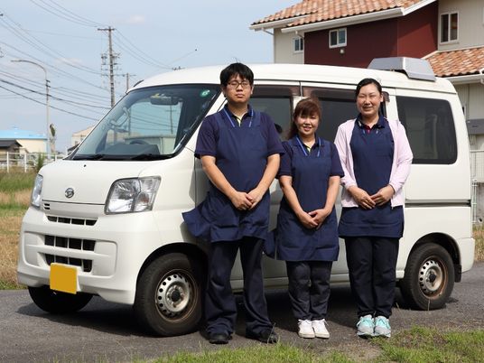 送迎車と職員の外観  
