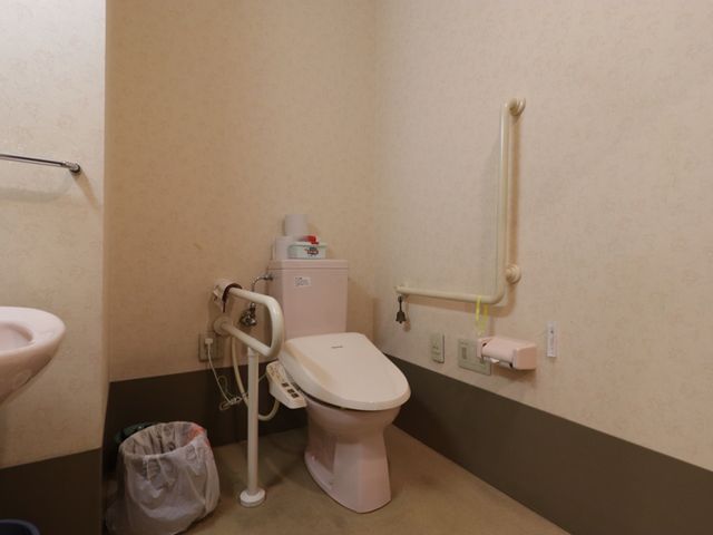 バリアフリートイレ トイレ 安全なサポートを提供する設計の清潔なトイレ空間です。手すりや暖房設備も整い、利用者の快適性を考慮しています。
