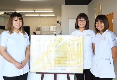 笑顔のスタッフと掲示物