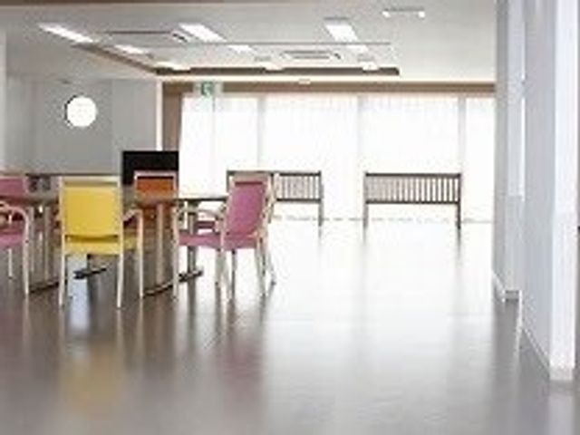 明るい共有スペース ラウンジ 窓から自然光が差し込む快適な空間です。色とりどりの椅子でリラックスして過ごせます。