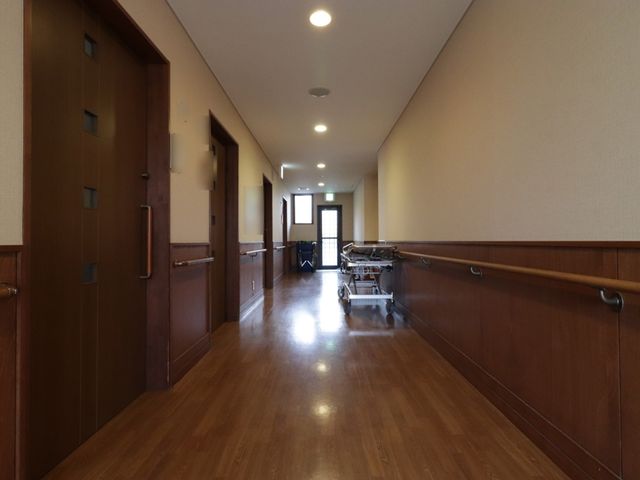 廊下の明るい通路 廊下 広々として清潔感のある通路が広がり、安全に配慮された手すりが設置されております。従業員の方々には、快適で使いやすい環境での業務が期待できます。