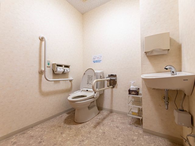 バリアフリートイレの内部 トイレ 手すり付きのトイレは、利用者の安全と利便性を考慮して設計されており、清潔感のある空間です。