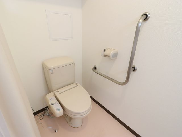 手すり付きトイレ トイレ 安全を考慮した手すりが設置された清潔なトイレです。快適にご利用いただける配慮が行き届いています。
