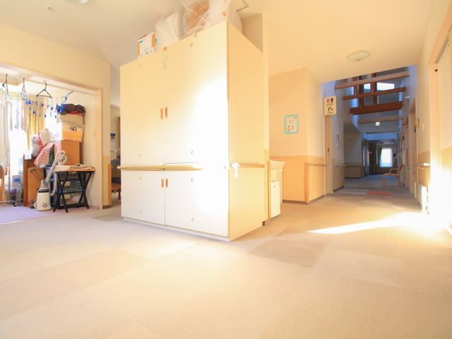 日差しが差し込む廊下 通路 やわらかな日差しを浴びながら、ゆったりとした空間で快適にお過ごしいただける通路です。通りに面した複数の扉が、利用者の活動範囲を広げます。