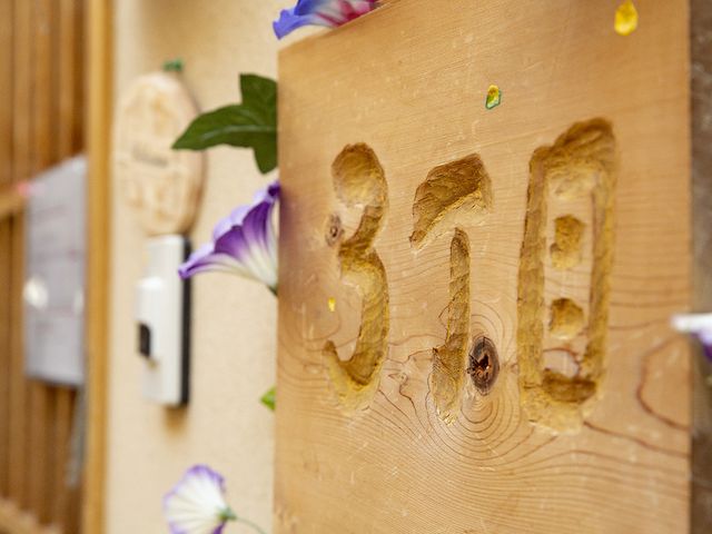 部屋番号が彫られた木製の表札 居室 木彫りの表札が印象的な居室です。温かみを感じさせる工夫が施されています。