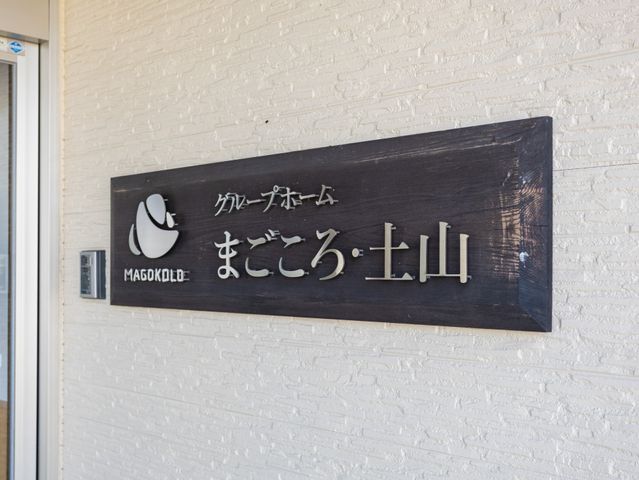 施設名の木製看板  