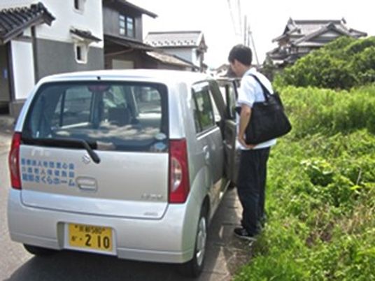 送迎車と乗降する人  