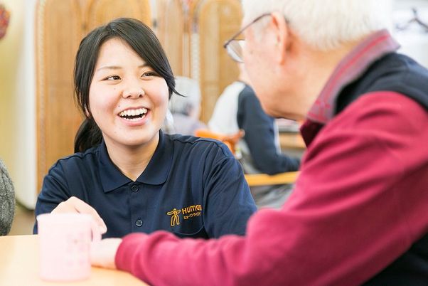 笑顔で会話するスタッフと高齢者