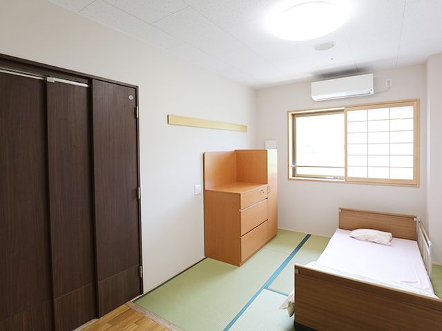 畳敷の洋室 居室 畳敷きの床にベッドが置かれた居室は、窓から自然光が差し込み、穏やかな雰囲気です。