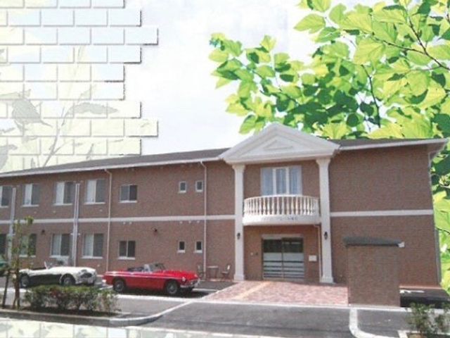 落ち着いた色の外観 外観 赤とクリーム色の外壁が印象的な建物です。緑に囲まれた静かな立地で、快適な職場環境をお求めの方に適しています。