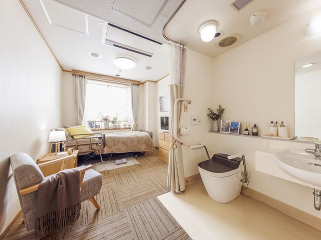 落ち着いた雰囲気のリビング 居室 温かみのある家具が整えられ、穏やかな光が差し込む共有スペースです。