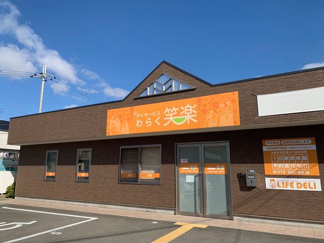 茶色い壁の建物正面 温かみのあるデザインの入口が特徴的な建物です。訪れる人々を優しく迎える雰囲気があります。