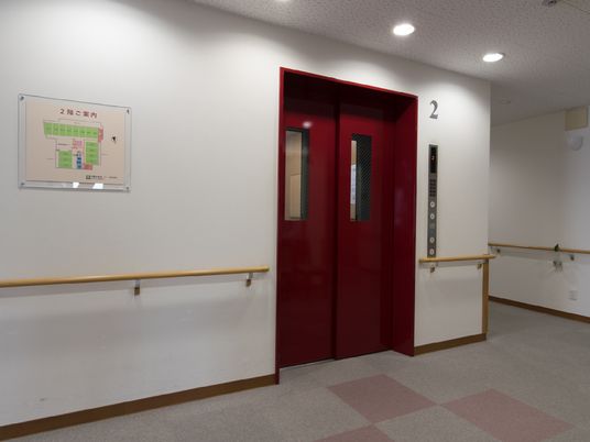 赤いエレベーターと掲示板