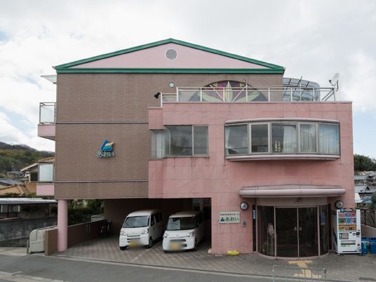 ピンクの建物エントランス