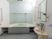 清潔感のある個室タイプの浴室である。広い洗い場の壁には鏡が取り付けられており、台の上に桶が置かれている。